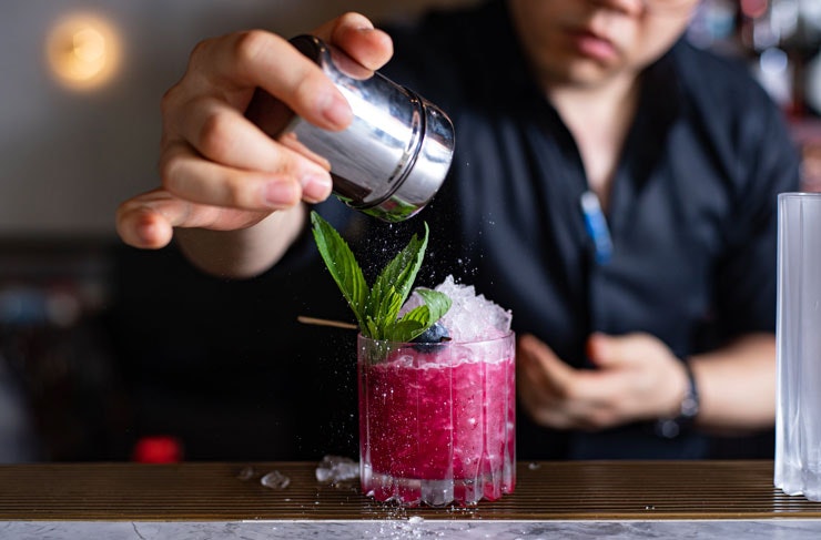 A bright pink cocktail being prepared at Ruse.